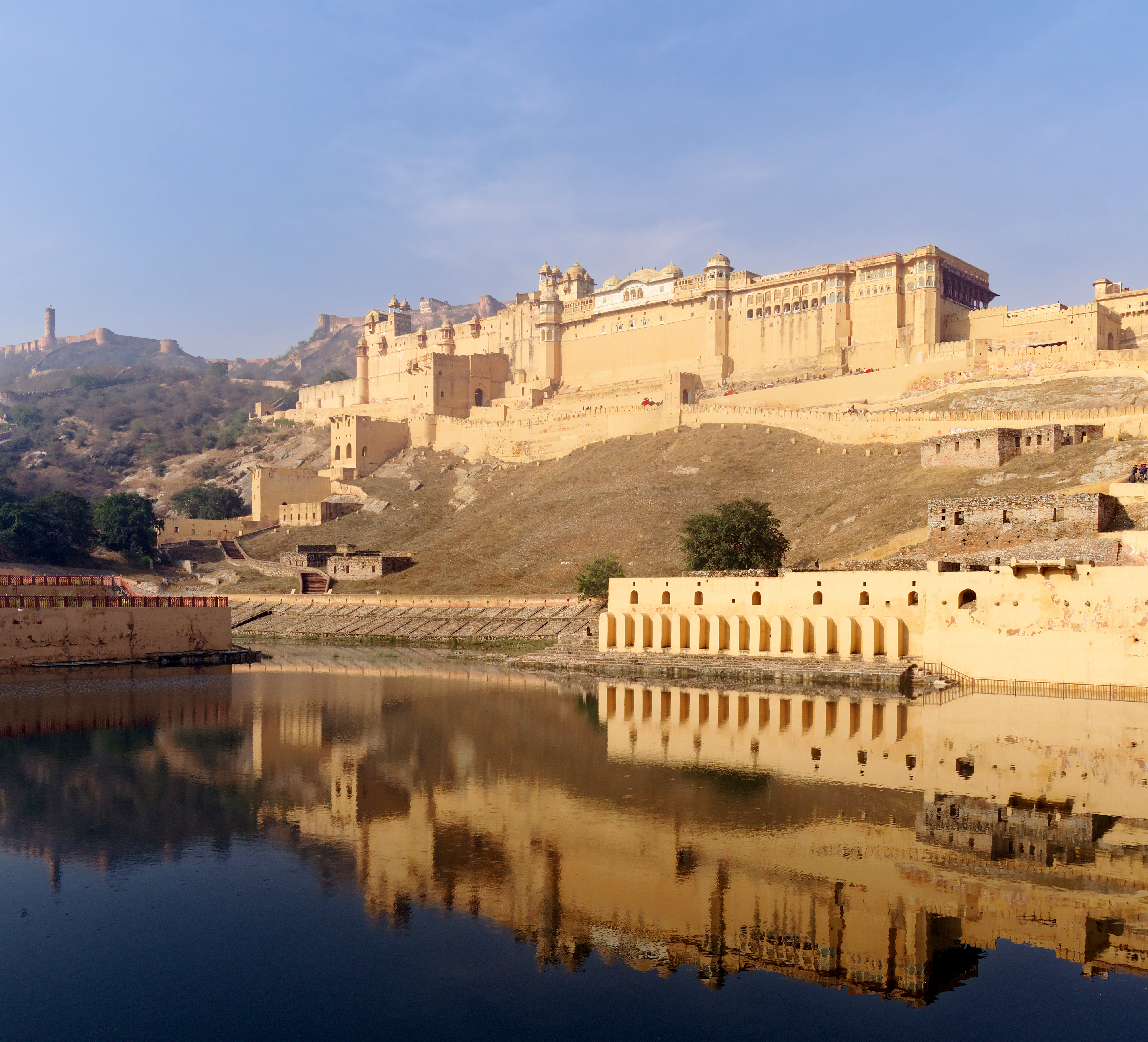 Amer Fort rising above Maota Lake in Jaipur at golden hour